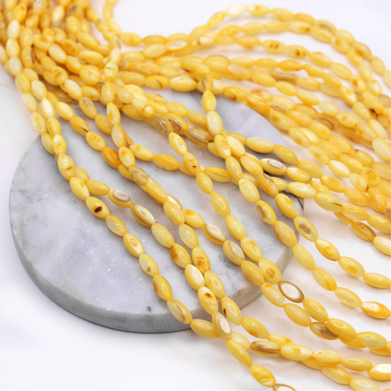 Shell beads/ yellow olives approx. 5x10mm/ string 38cm MU139C