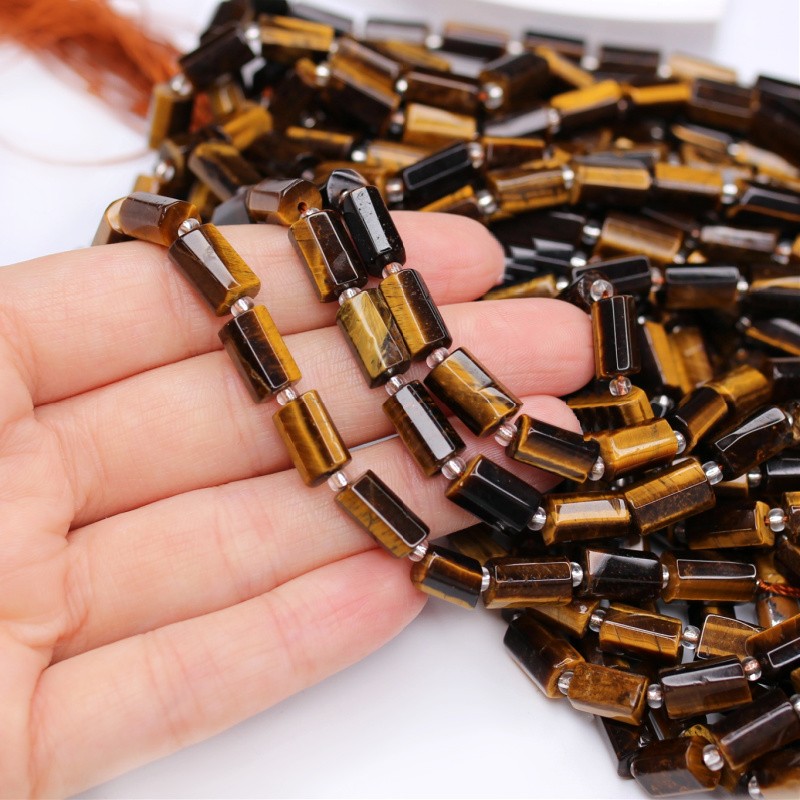 Tiger eye/ faceted irregular rollers approx. 7x11mm/ 15 pcs/ cord KATEWA01